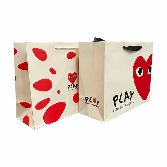 Materials 2 paper bags with 4C printing and handles