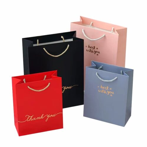Bags 4 paper bags with gold / silver handles with gold logos.